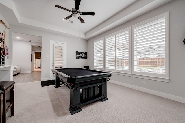 playroom featuring light carpet, a tray ceiling, pool table, and ceiling fan