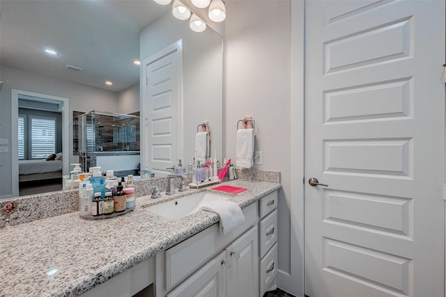 bathroom featuring vanity and an enclosed shower