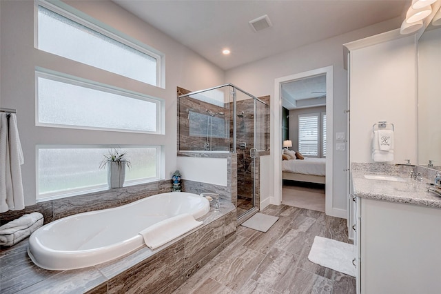 bathroom featuring vanity and shower with separate bathtub