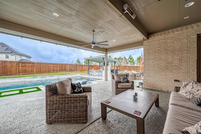 view of patio / terrace with ceiling fan, an outdoor living space, and a fenced in pool