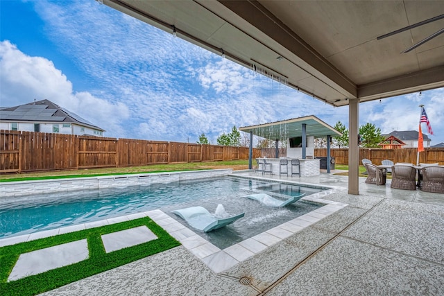 view of pool with a patio and a bar