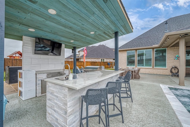 view of patio with an outdoor wet bar