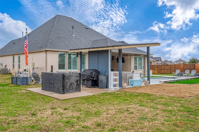 back of house featuring a yard and a patio