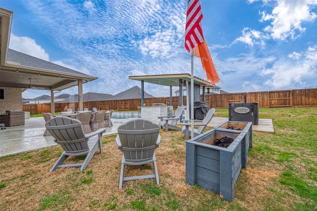 view of yard with a swimming pool, a patio area, and an outdoor fire pit