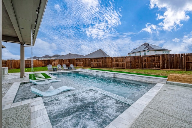 view of swimming pool with pool water feature, a patio, and a lawn