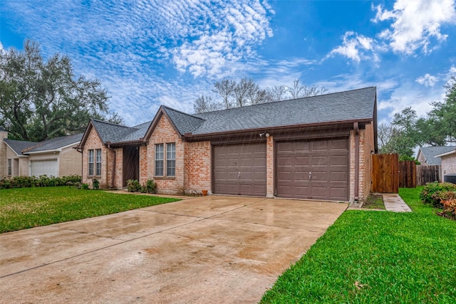 ranch-style home featuring a garage and a front lawn