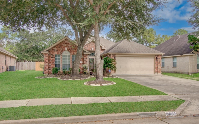 view of front facade featuring a garage, a front yard, and central air condition unit