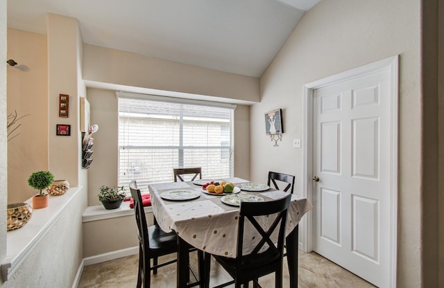 dining area with lofted ceiling