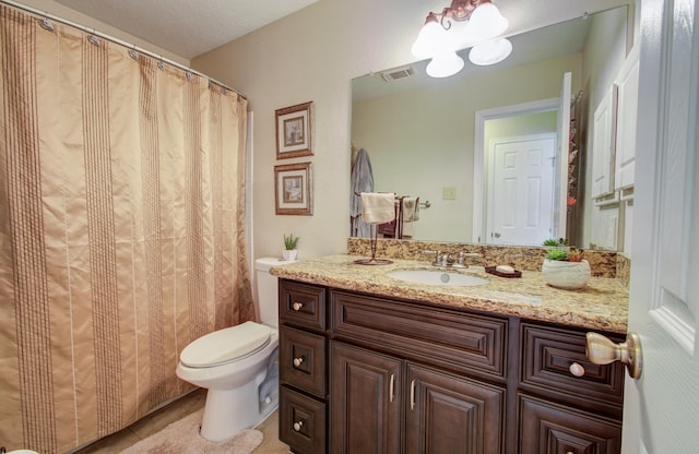 bathroom featuring vanity, toilet, and tile patterned flooring