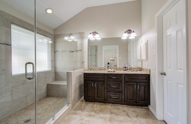 bathroom with lofted ceiling, vanity, and walk in shower