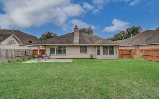 back of property featuring a patio and a lawn