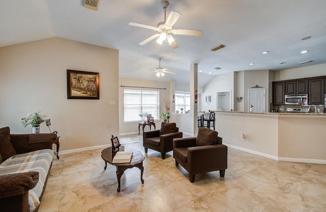 living room with ceiling fan, sink, and vaulted ceiling