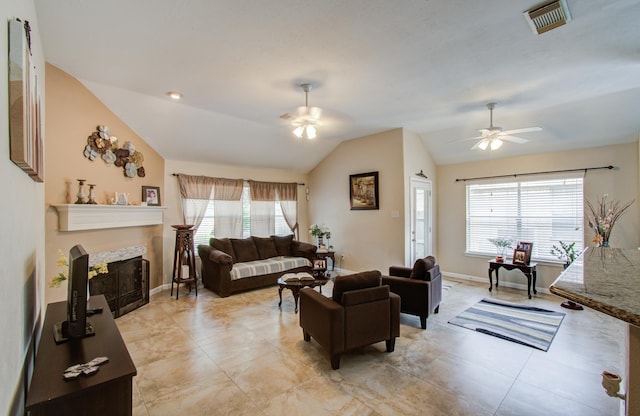 living room featuring ceiling fan, lofted ceiling, and a wealth of natural light