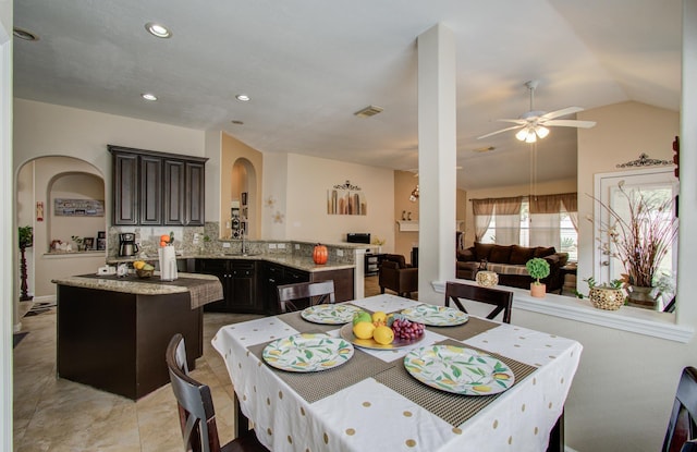 dining space with sink, vaulted ceiling, and ceiling fan