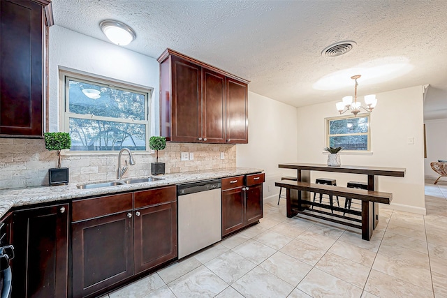 kitchen with sink, light stone counters, dishwasher, pendant lighting, and decorative backsplash