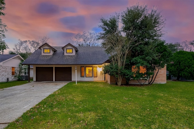 view of front of home featuring a garage and a lawn