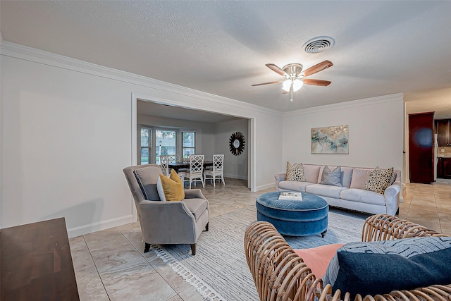 living room featuring ornamental molding, ceiling fan, and a textured ceiling