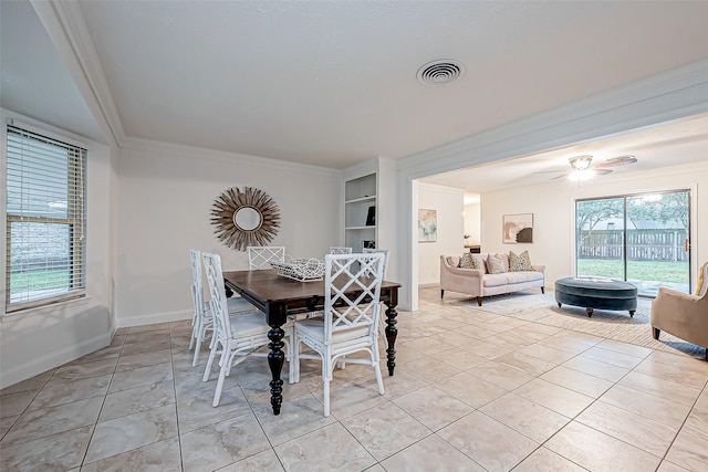 tiled dining room with crown molding and ceiling fan