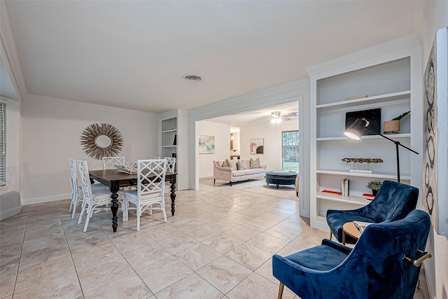 tiled dining area featuring crown molding and built in features