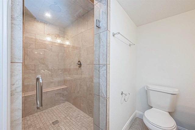 bathroom featuring toilet and a shower with shower door