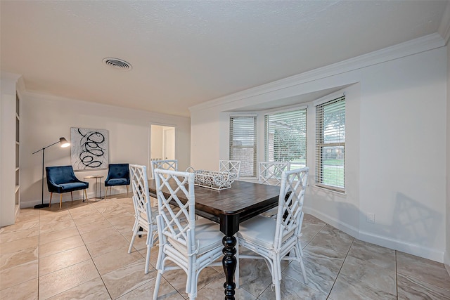 tiled dining area featuring ornamental molding