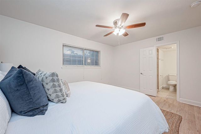 bedroom with light hardwood / wood-style flooring, ceiling fan, and ensuite bathroom