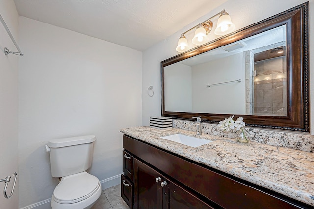 bathroom featuring vanity, tile patterned floors, and toilet