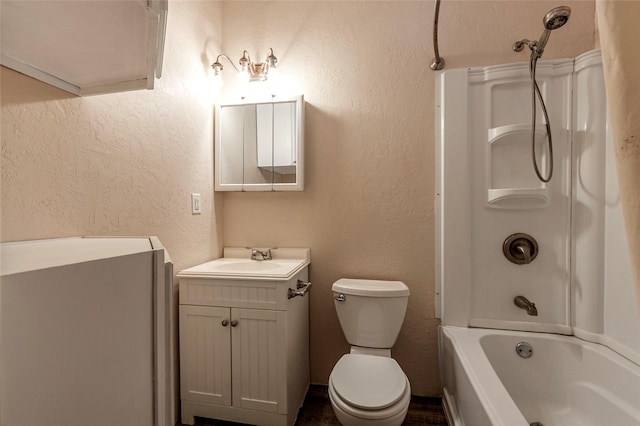 full bath with vanity, toilet,  shower combination, and a textured wall