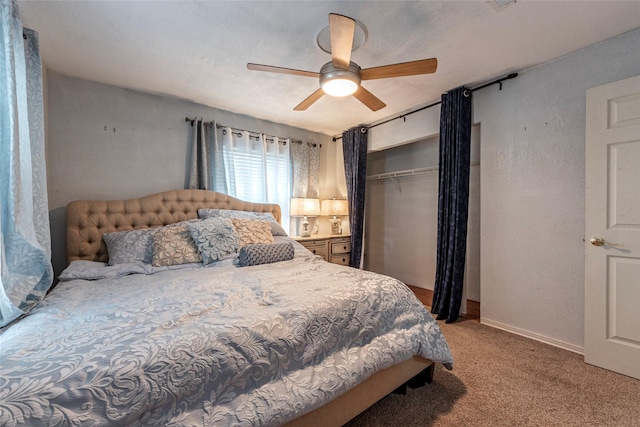 carpeted bedroom with a closet, baseboards, ceiling fan, and a textured wall