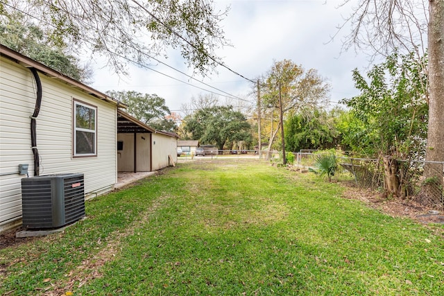 view of yard featuring a fenced backyard and central AC