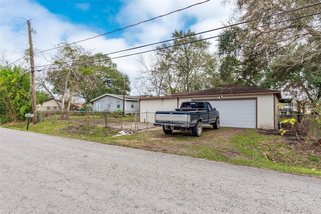 single story home with an outbuilding, fence, and a garage