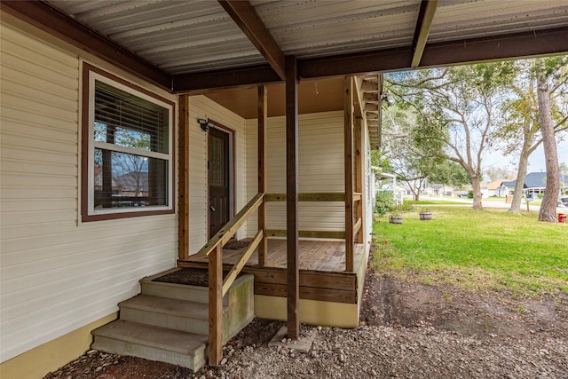 entrance to property with a lawn