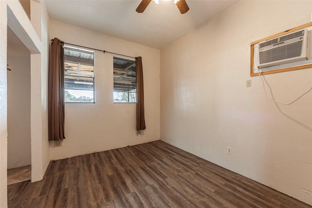 empty room with wood finished floors, a ceiling fan, and a wall unit AC