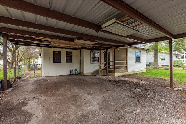 exterior space featuring an attached carport and fence