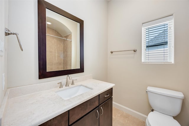 bathroom with vanity, tile patterned floors, toilet, and walk in shower