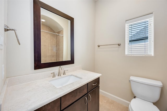full bath featuring vanity, baseboards, tile patterned floors, and toilet