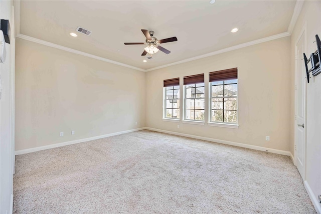 carpeted spare room featuring crown molding and ceiling fan