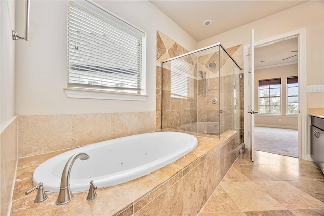 bathroom with a tub with jets, a stall shower, and vanity