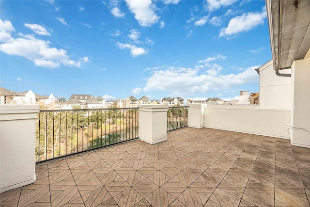 view of patio featuring a balcony and a residential view