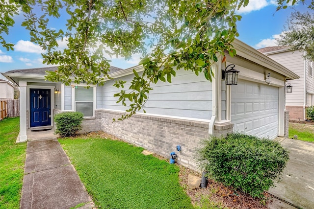 single story home with a garage and a front yard