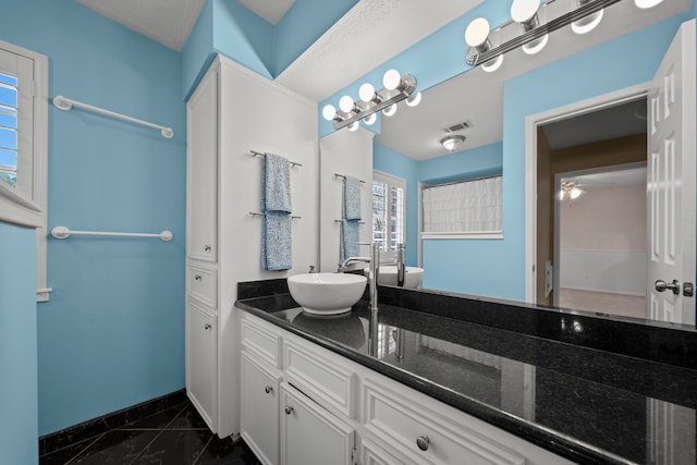 bathroom with baseboards, visible vents, and vanity