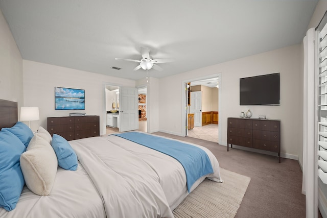 bedroom featuring carpet, connected bathroom, visible vents, and baseboards