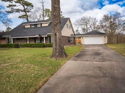 view of front of home with a garage and a front lawn