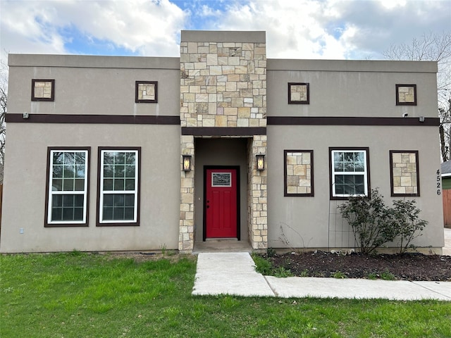 view of front of property with stone siding, stucco siding, and a front lawn