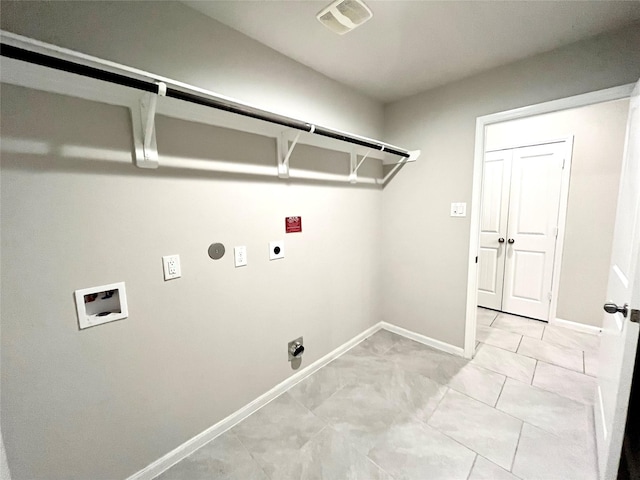 clothes washing area featuring light tile patterned floors, hookup for an electric dryer, gas dryer hookup, and hookup for a washing machine