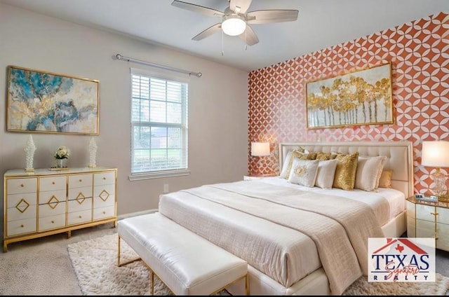 bedroom with wallpapered walls, a ceiling fan, and carpet floors