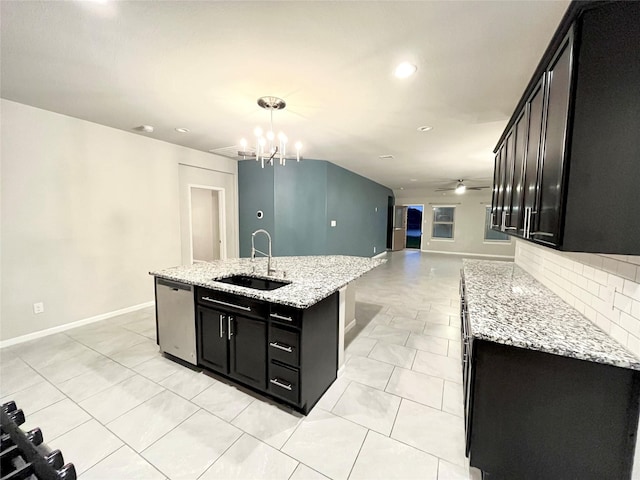 kitchen featuring sink, a kitchen island with sink, light stone countertops, and dishwasher