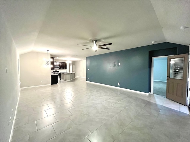 unfurnished living room with lofted ceiling, ceiling fan, and light tile patterned floors