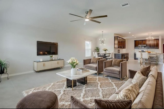 living room with ceiling fan with notable chandelier