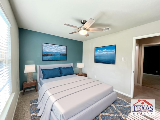 carpeted bedroom featuring visible vents, ceiling fan, and baseboards